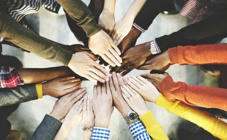 group of hands in a circle